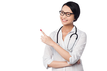 Image showing Female physician pointing and looking away