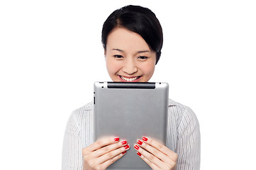 Image showing Shy pretty corporate lady holding tablet device