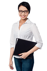 Image showing Smiling female executive holding business files