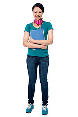 Image showing College girl with headphones around her neck