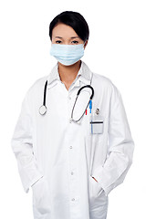 Image showing Female surgeon posing with hands in lab coat