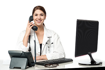 Image showing Female physician answering phone call