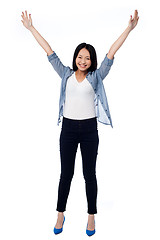 Image showing Joyous female raising arms in excitement