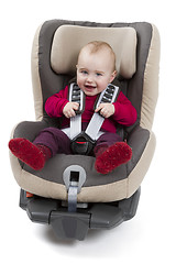 Image showing child in booster seat for a car in light background