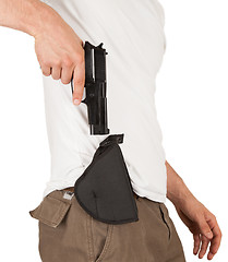 Image showing Close-up of a man with holster and a gun