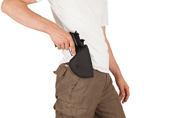 Image showing Close-up of a man with holster and a gun