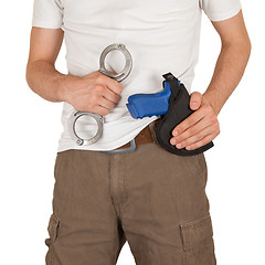 Image showing Close-up of a man with holster and a gun