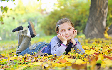 Image showing little girl  laying on the grass