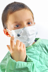 Image showing doctor boy with protective mask preparing to inject 
