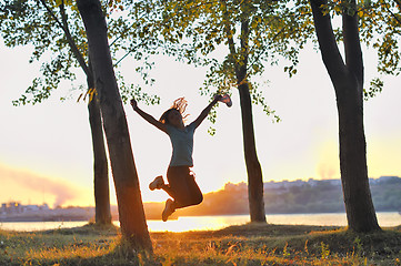 Image showing girl jumping over sunset
