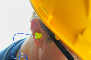 Image showing yellow earplug into the ear