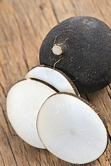 Image showing Black radish on a wooden board