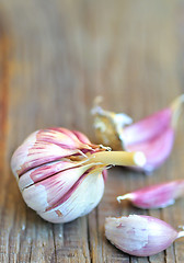 Image showing young garlics on wooden background