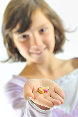 Image showing girl holding  pills 