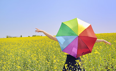 Image showing a young attractive girl with a colorful umbrella