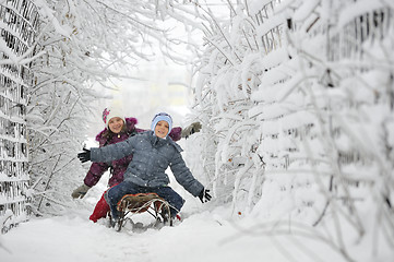 Image showing Kids sliding in winter time