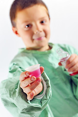 Image showing little doctor boy giving syrup