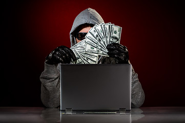 Image showing Hacker and money