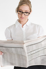 Image showing Businesswoman reading financial newspaper