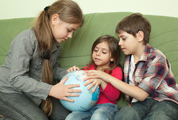 Image showing Kids looking at globe