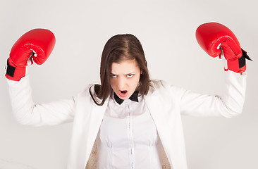 Image showing Angry businesswoman in boxing gloves