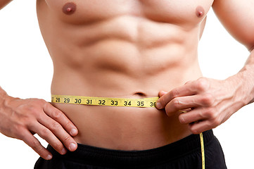 Image showing Fit Man Measuring His Waist