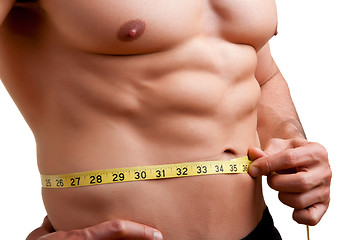 Image showing Fit Man Measuring His Waist