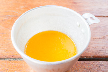 Image showing Bakery melt butter measured in plastic  cup 