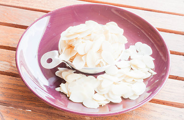 Image showing Bakery raw sliced  almonds in measured cup 