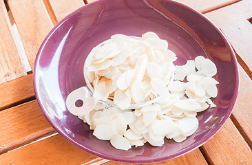 Image showing Bakery raw sliced  almonds in measured cup 