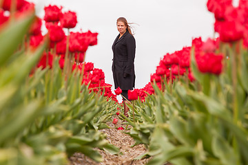 Image showing Woman standing in a field of tulips