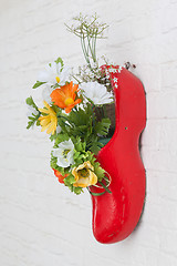 Image showing Dutch wooden shoe with fake flowers