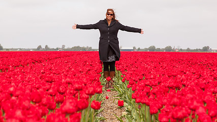 Image showing Woman standing in a field of tulips