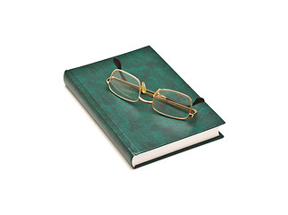 Image showing Green book and glasses, isolated on white background