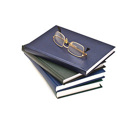 Image showing Stack of books and glasses, isolated on white background
