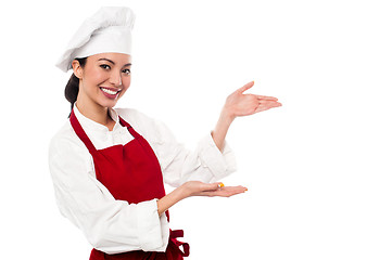 Image showing Female chef presenting something