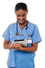 Image showing Female physician operating tablet pc