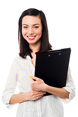 Image showing Female assistant holding business files