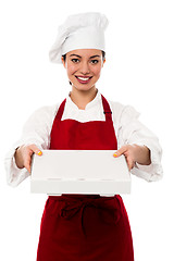 Image showing Attractive asian female chef delivering pizza