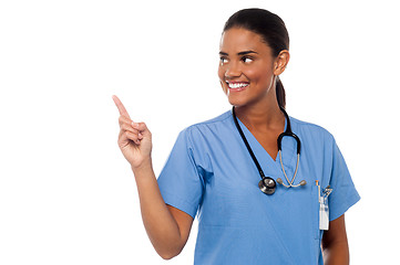 Image showing Female physician pointing and looking away