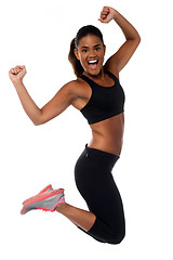 Image showing Woman in sportswear jumping with joy