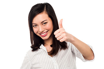 Image showing Smiling young woman showing thumbs up