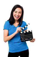 Image showing Young girl holding clapperboard