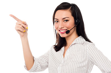 Image showing Asian call center executive pointing away