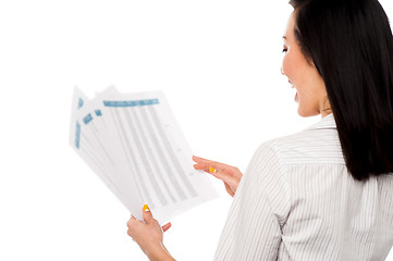 Image showing Cheerful female manager holding business reports