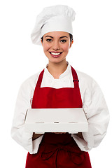 Image showing Attractive asian female chef delivering pizza