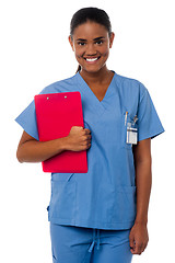 Image showing Active female nurse holding clipboard, at duty