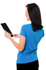 Image showing Smiling attractive girl operating touch pad device