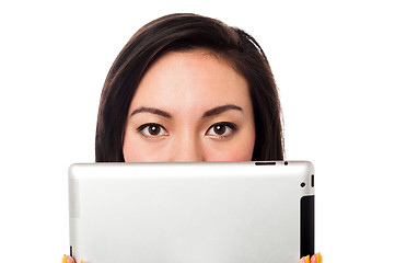 Image showing Asian model hiding her face with tablet device