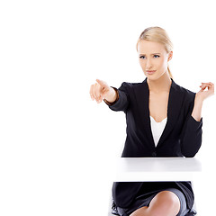 Image showing Sexy blond business woman sitting in front of desk